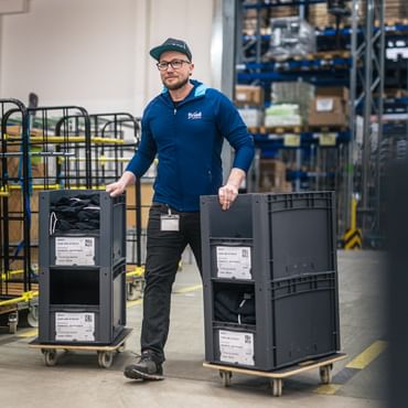 Tom moves crates of goods through logistics