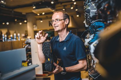 an employee presents a hiking shoe
